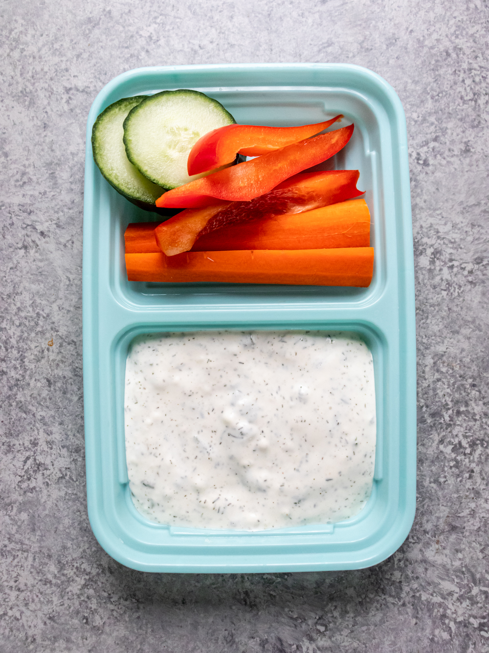 Keto ranch dressing and veggies in a meal prep container